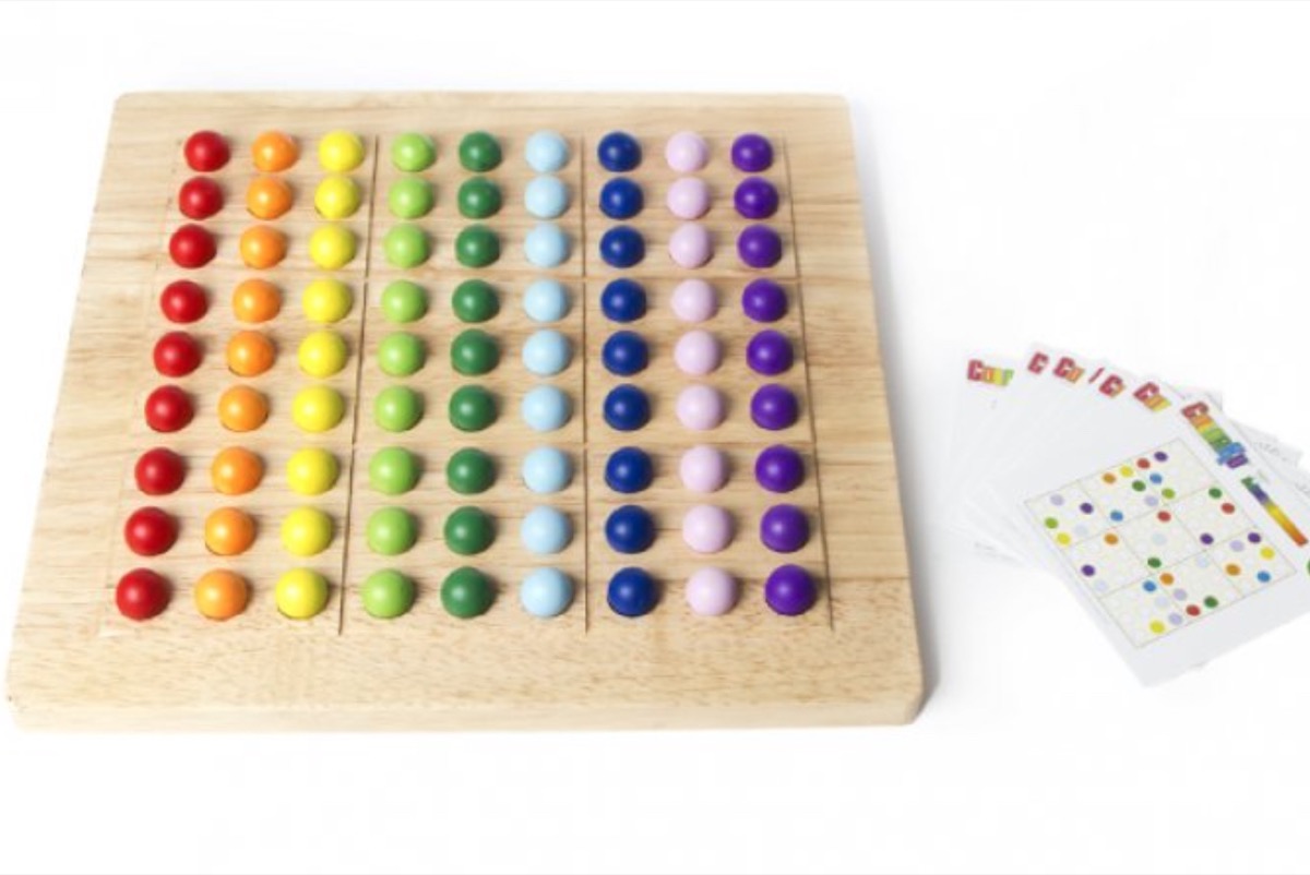 rows of colorful marbles on wooden board