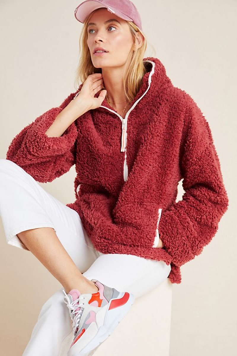 Woman wearing deep red sherpa pullover