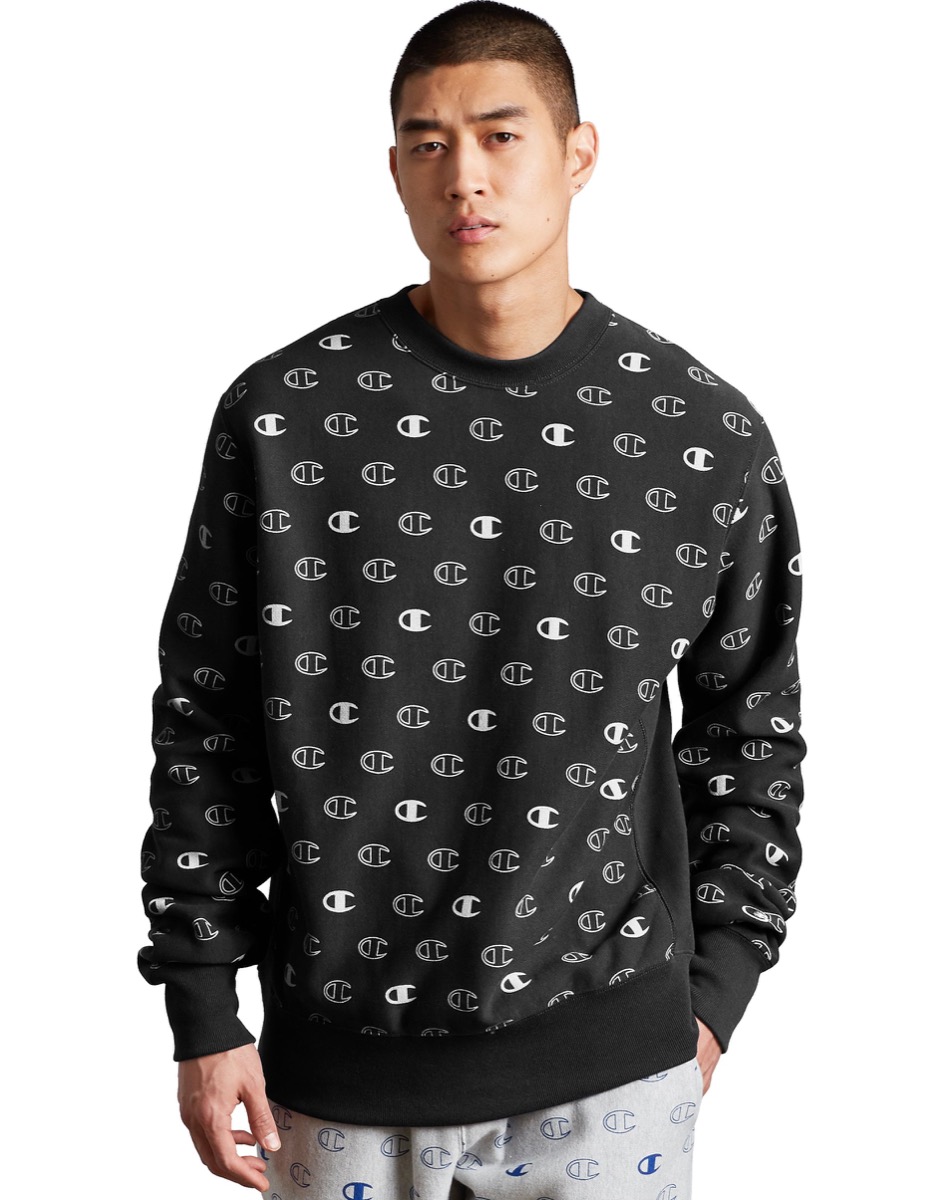 Man wearing logo sweater