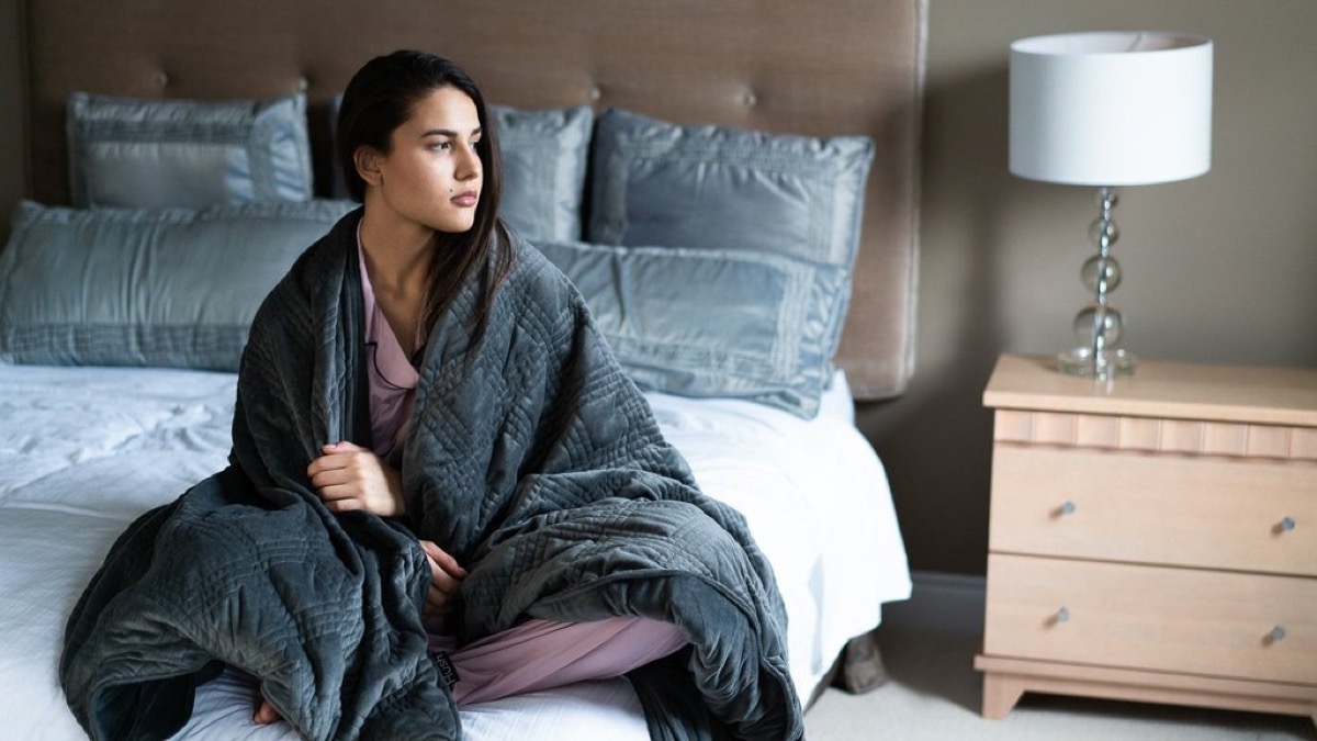 Woman using weighted blanket