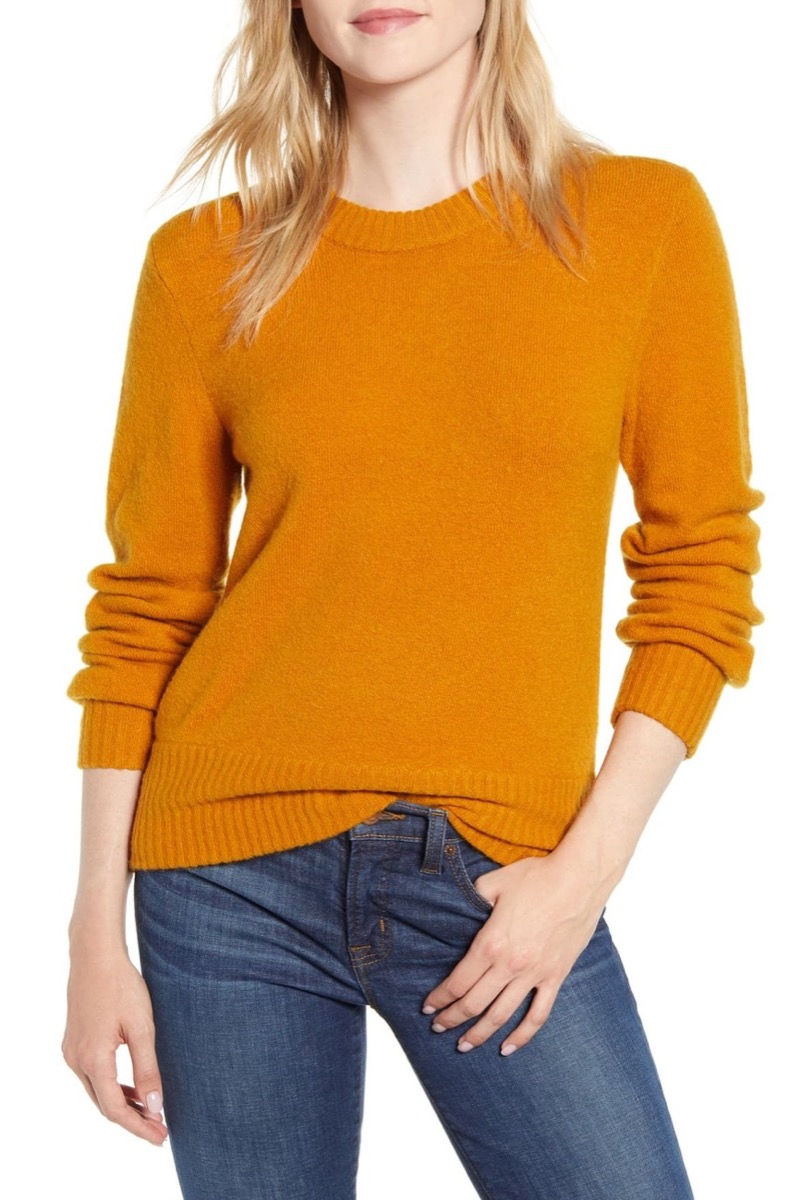 Woman wearing marigold color sweater