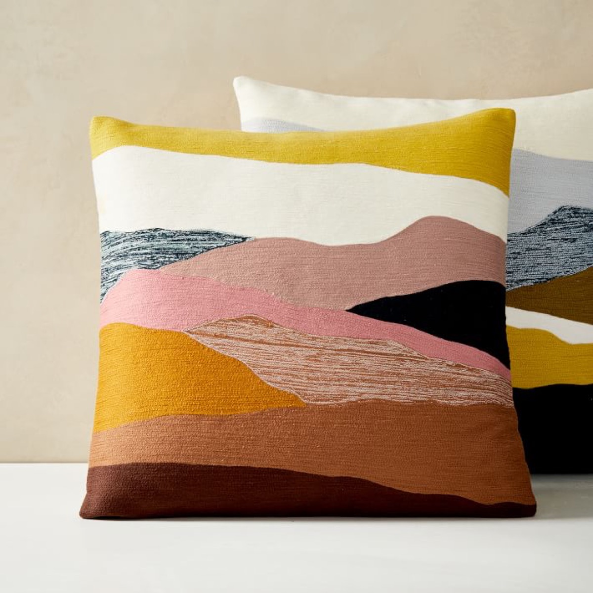 two embroidered landscape pillows