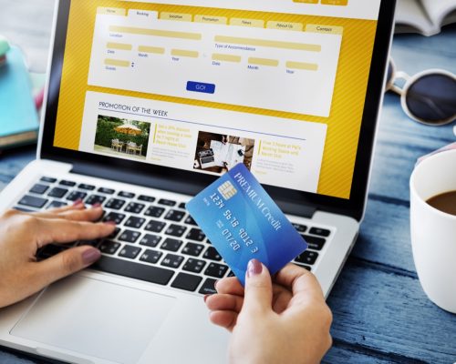 woman booking hotel room online with credit card