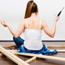 woman building furniture stressed