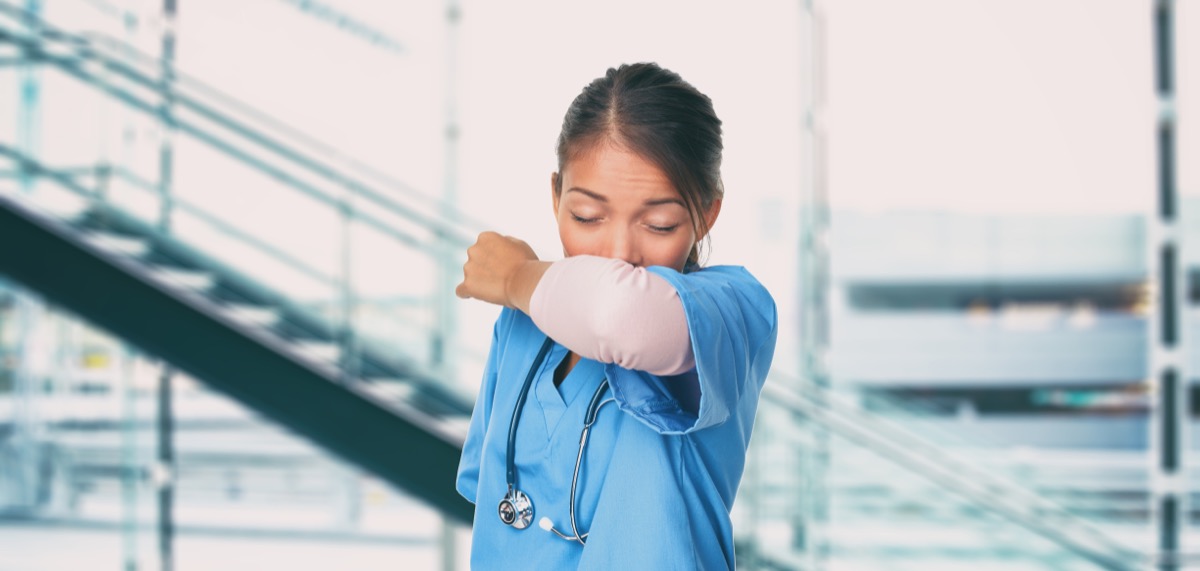 Female nurse coughing into her elbow correctly