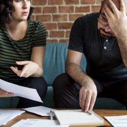 couple looking at paperwork with fine
