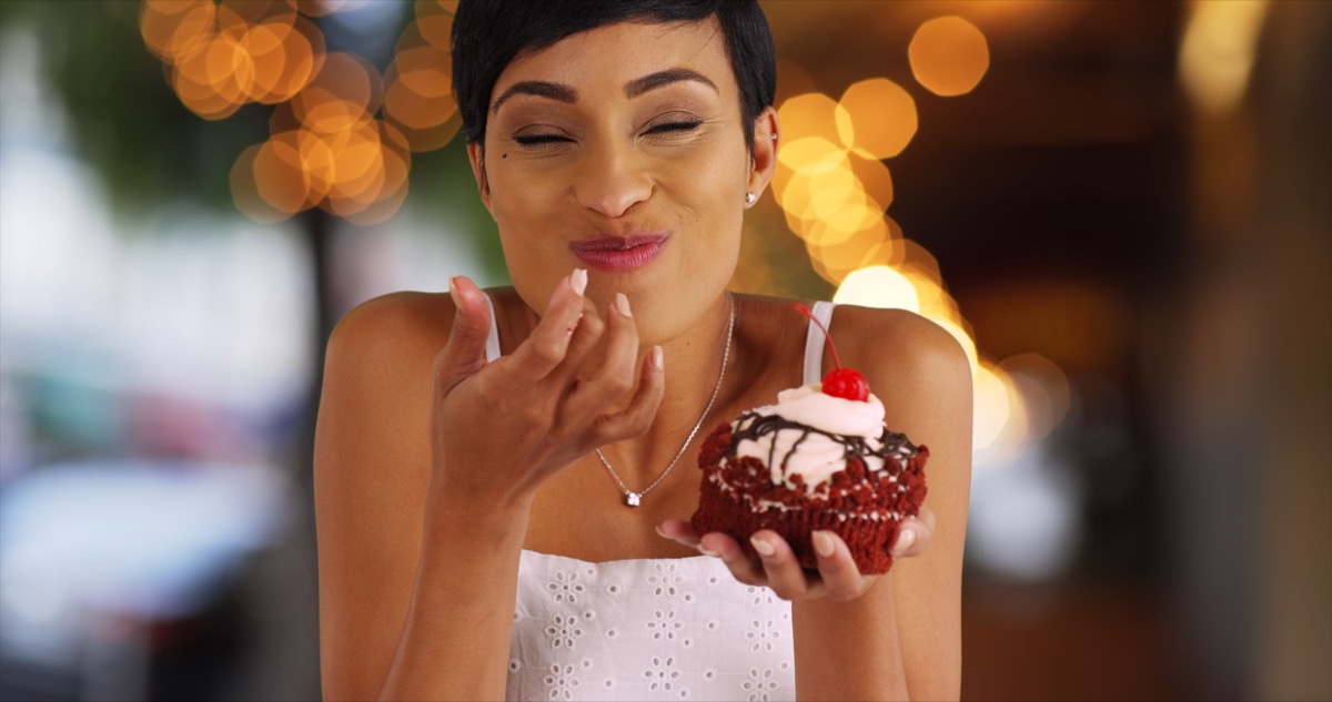 Woman enjoying eating cupcake