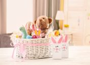 large white easter basket with pink bow on white table