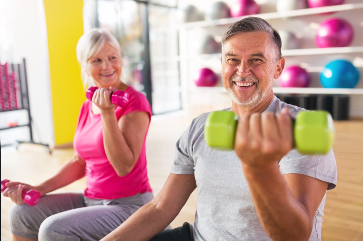Older couple exercising lifting weights