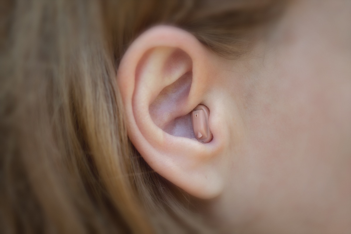 girl's ear with hearing aid