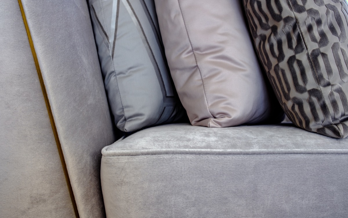 gray silk couch with throw pillows