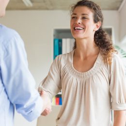Woman shaking hands meeting man