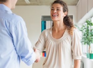 Woman shaking hands meeting man