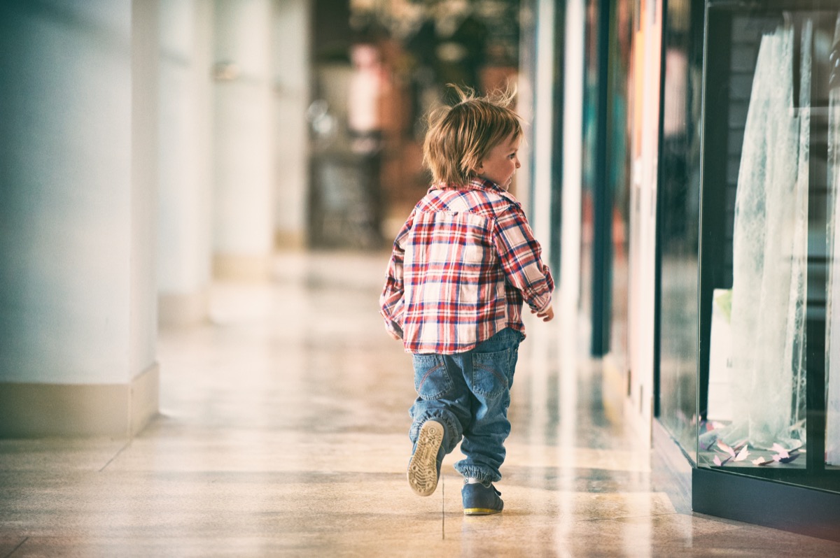 little boy running through mall
