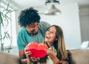 Man giving his girlfriend or wife a heart-shaped present