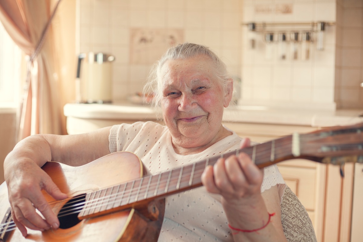 Older woman playing gutair