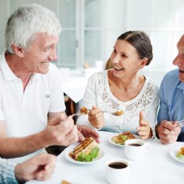 group of older white adults having lunch together