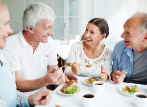group of older white adults having lunch together