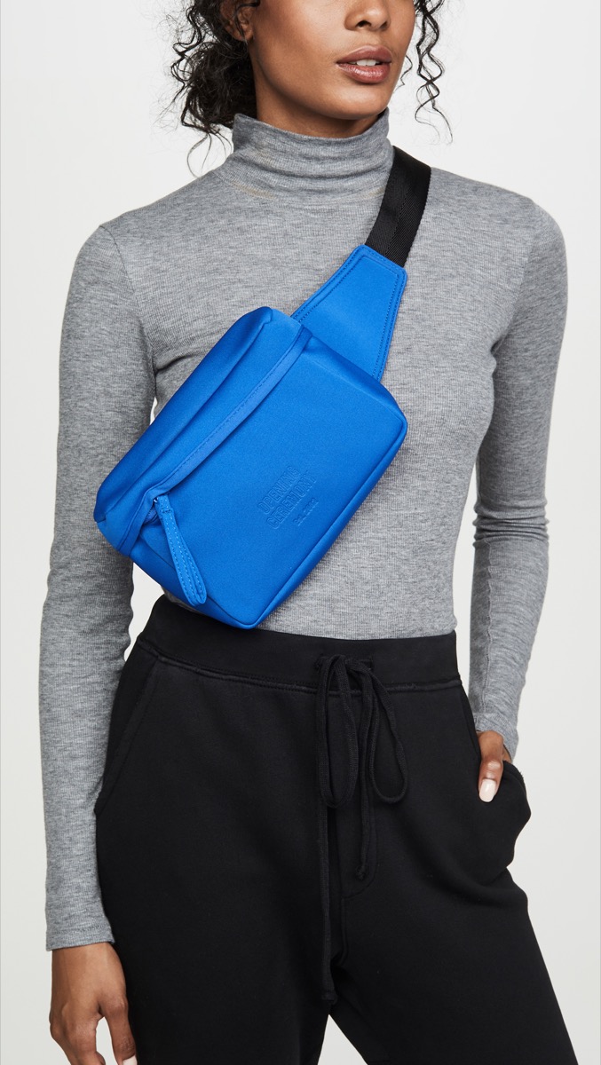 young black woman wearing blue fanny pack across torso