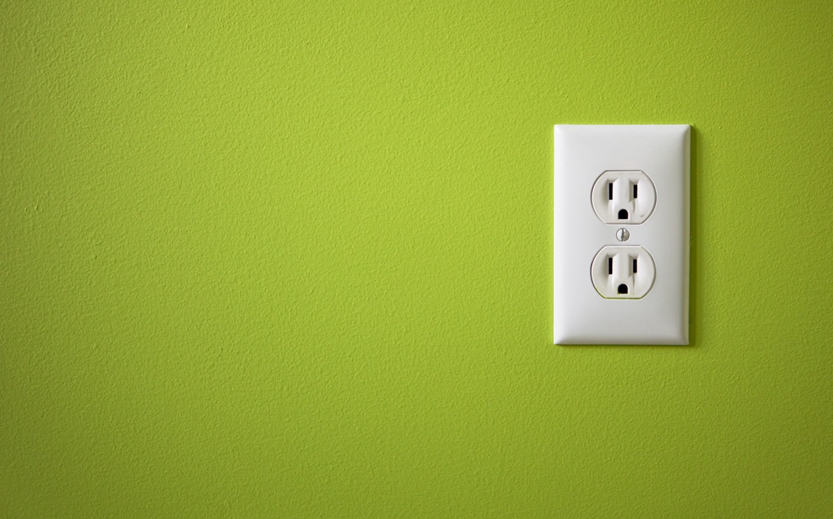 Electrical outlet on green wall