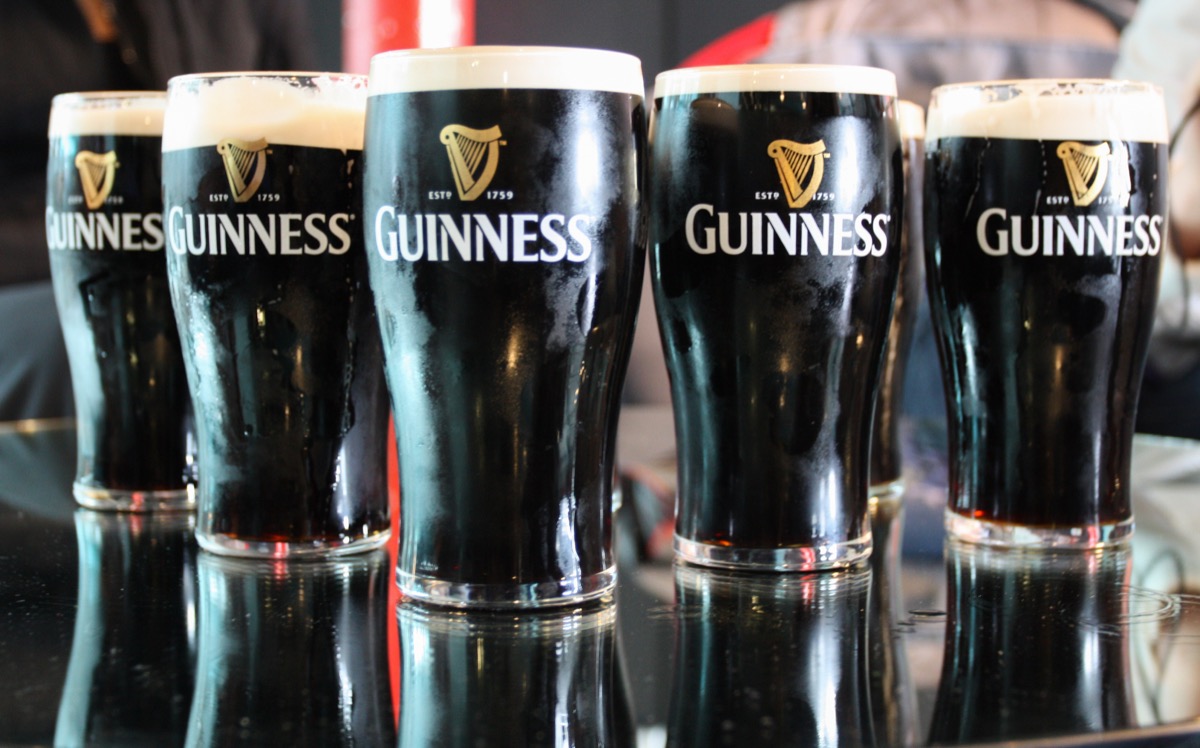 a few pints of Guinness standing on the table.