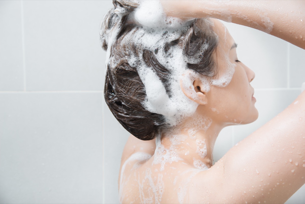 Woman shampooing her hair in the shower