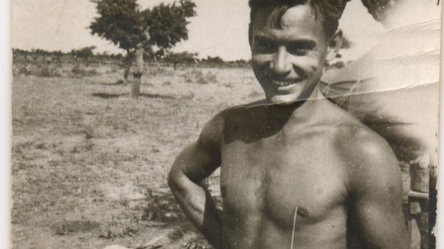 1940s black and white photo of shirtless man