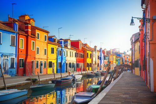 rainbow houses on a canal in burano, italy