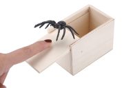 white hand and spider coming out of box