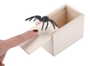 white hand and spider coming out of box