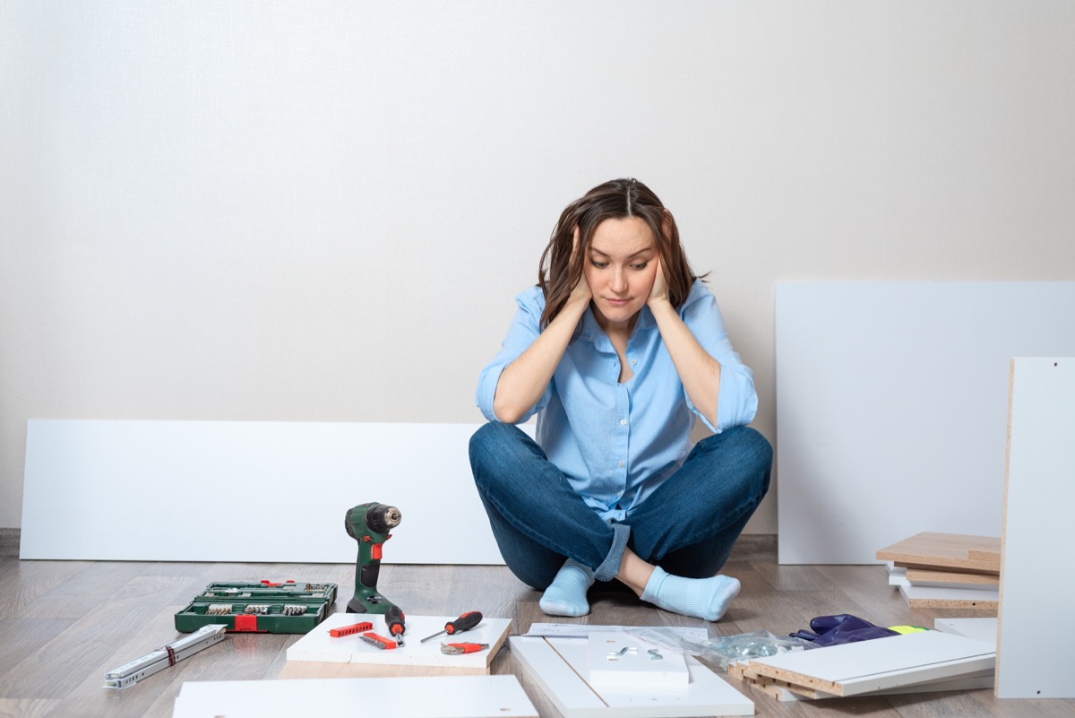 Woman stressed about putting furniture together DIY