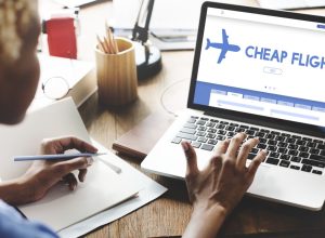 woman checking cheap flights on her laptop