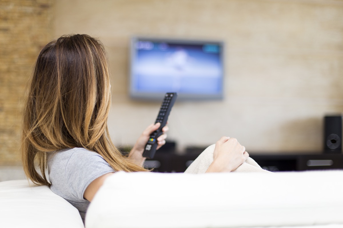 Woman watching tv on couch