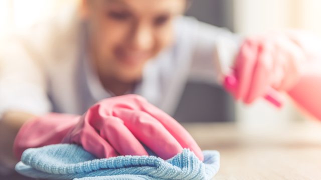 Woman cleaning with microfiber cloth