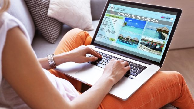 woman making hotel reservation online