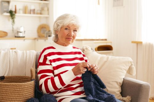 Woman knitting on couch
