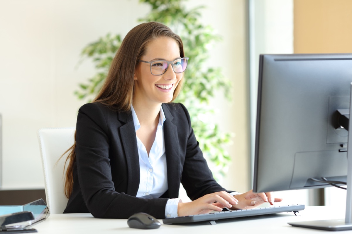 woman working on computer smiling