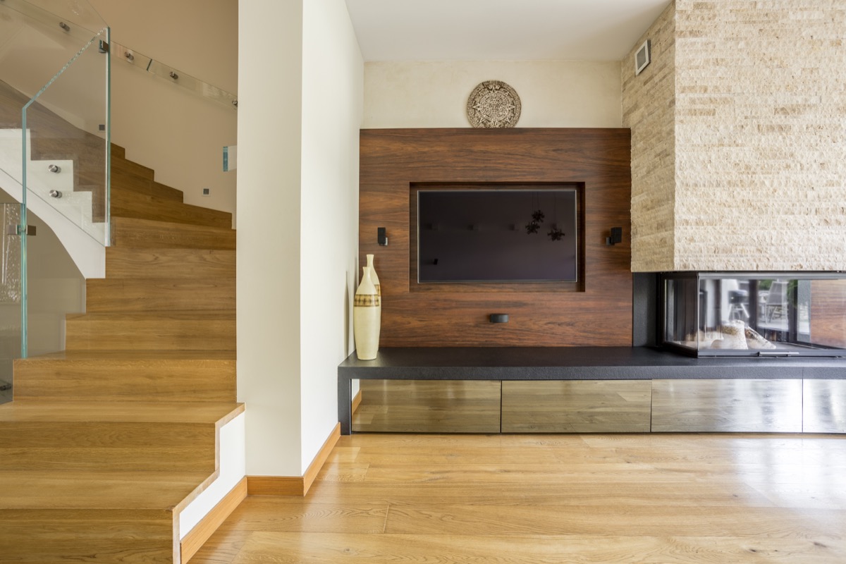 fireplace with wood paneling around it