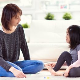 young asian mom talking to daughter