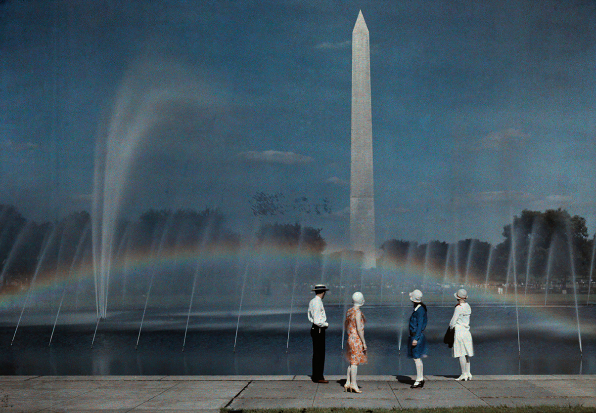 four people look at the Washington monument in the 1930s