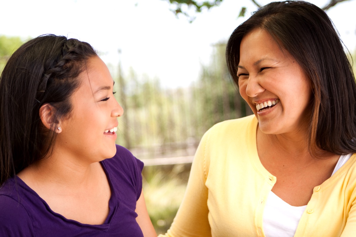happy asian mother and daughter talking