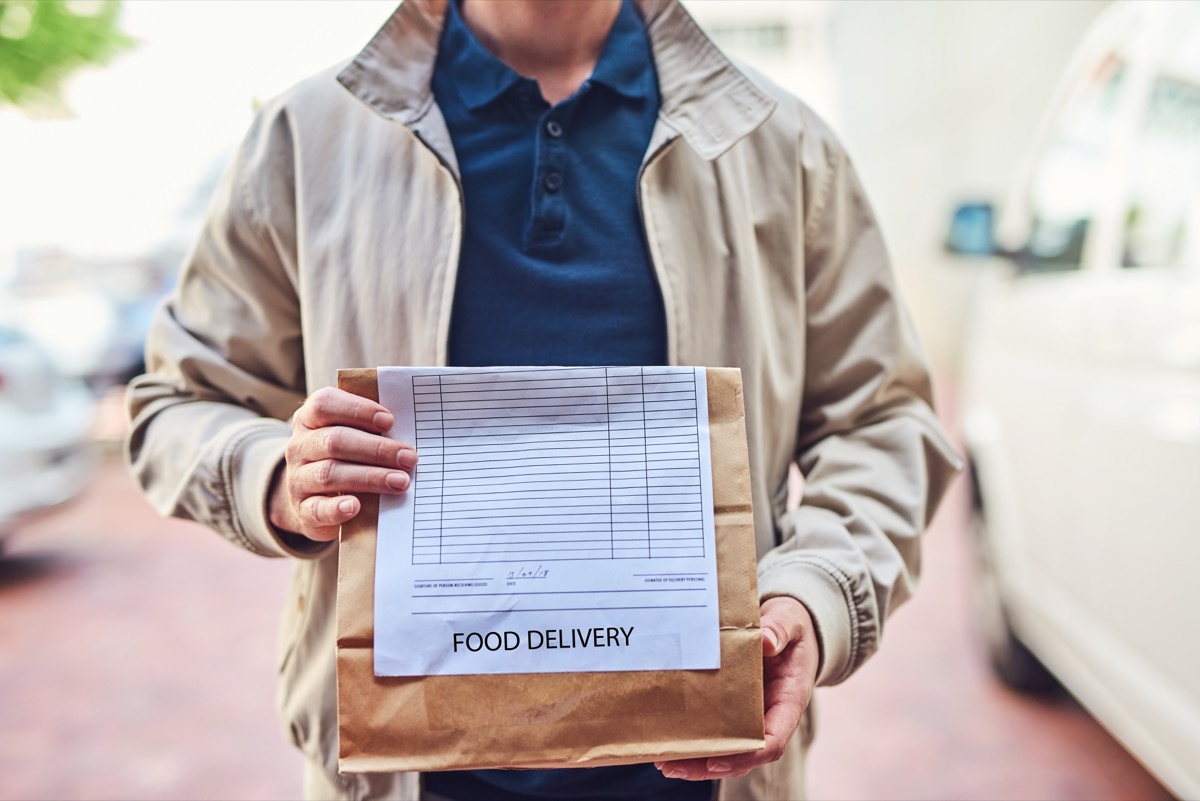 Closeup shot of an unrecognizable man making a food delivery