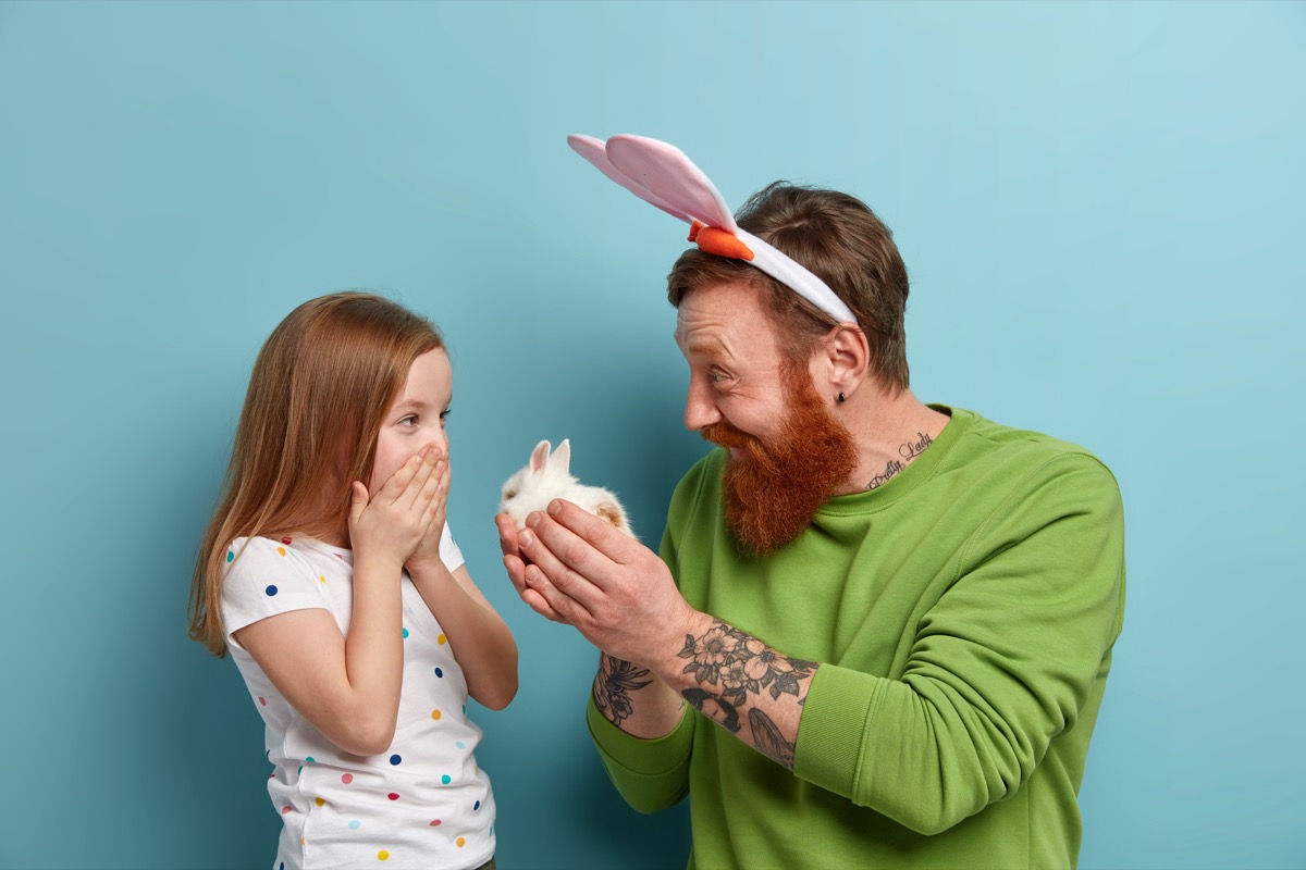 Dad giving daughter bunny as Easter gift