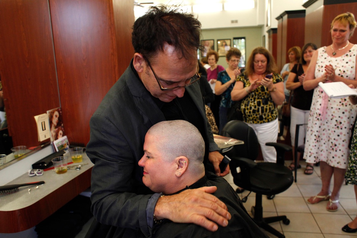 D66W6A April 12, 2013 - Largo, Florida, U.S. - LARA CERRI | Times.Bonnie Dhonau gets a hug from salon owner Damiano Marchiafava after he shaved her head at Avantaggio Salon in Largo Friday, April 12, 2013. Dhonau knows that the chemo she is about to receive for her breast cancer will take her hair. So instead of waiting for it to fall out in clumps on her pillow, she is taking matters into her own hands. (Credit Image: © Lara Cerri/Tampa Bay Times/ZUMAPRESS.com)