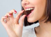 Woman eating piece of chocolate