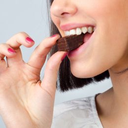 Woman eating piece of chocolate