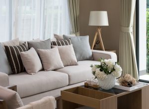 crowded living room with beige sofa