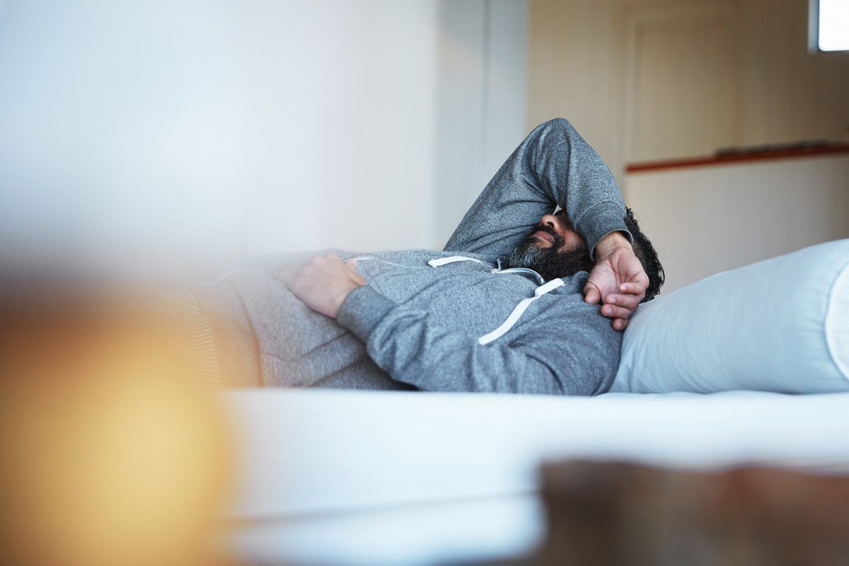 Shot of a mature man lying on his bed feeling exhausted