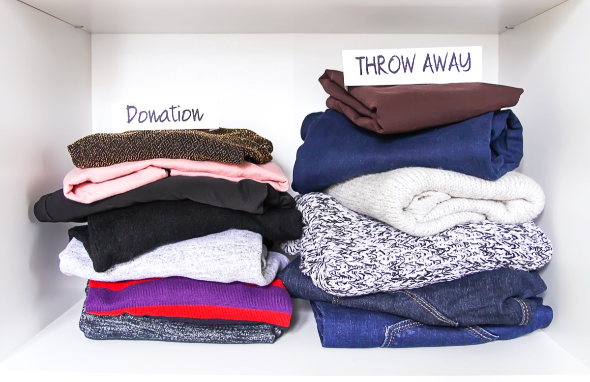 clothing sorted into donation and throw away piles