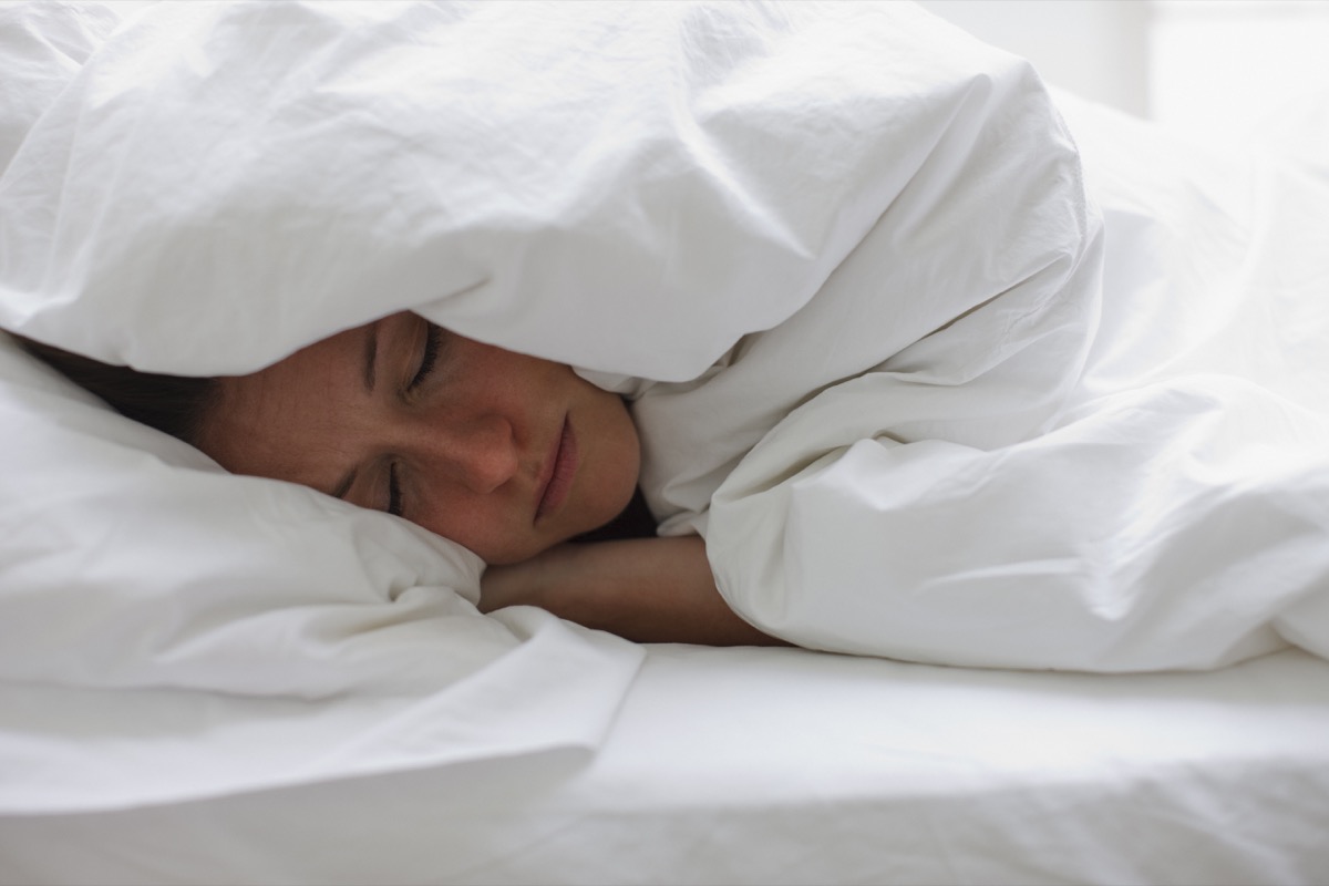 sick woman wrapped up in blankets